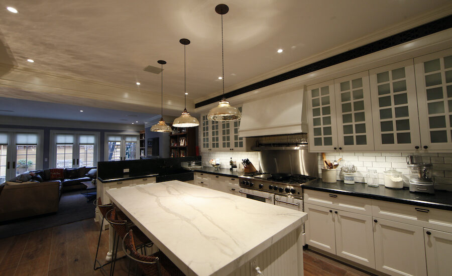 A kitchen is illuminated with soft lights for ambiance.